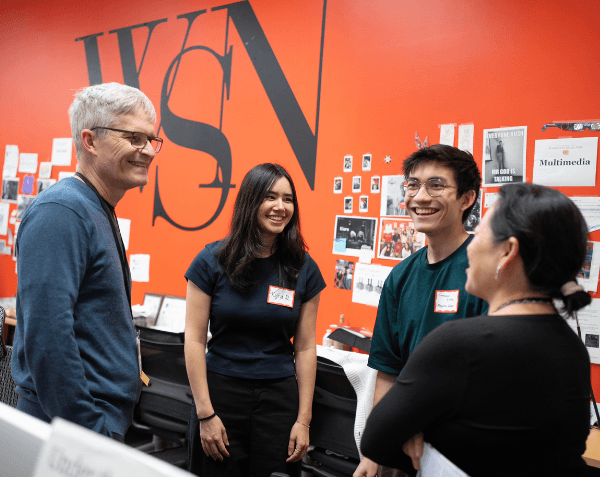 Alumni talking at Washington Square News headquarters