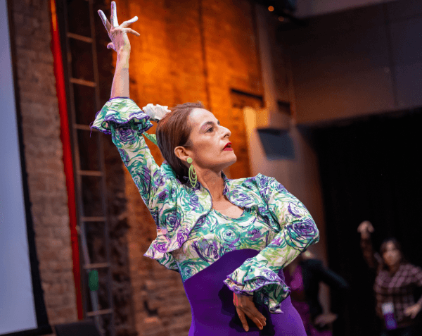 A Flamenco dance teacher teaching attendees that dance