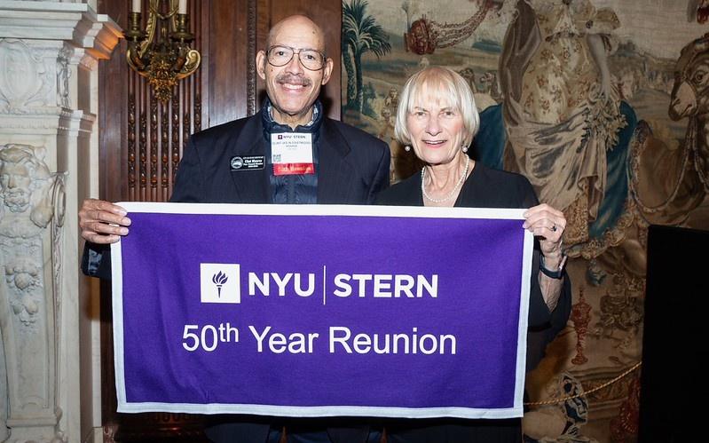 Alumni posing with a "50th Year Reunion" banner