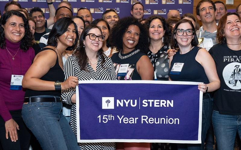 Group shot from Reunion 2025 of alumni holding a "15th Year Reunion" banner